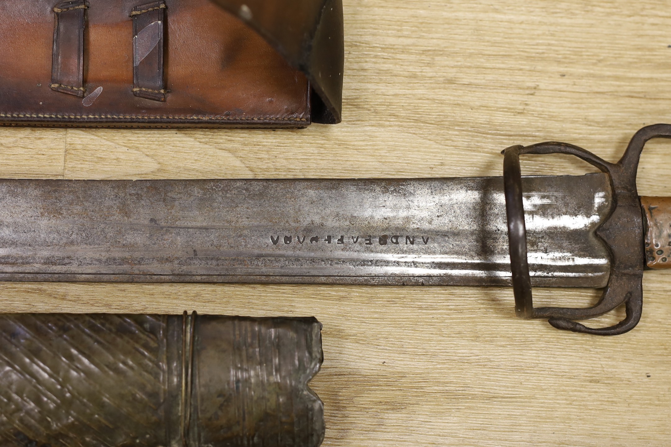 A Moroccan nimcha sword with associated Andrea Ferrara (Scottish) blade and a scabbard together with a court sword and an Aston & Mander Ltd. Mk VI military rule in leather case